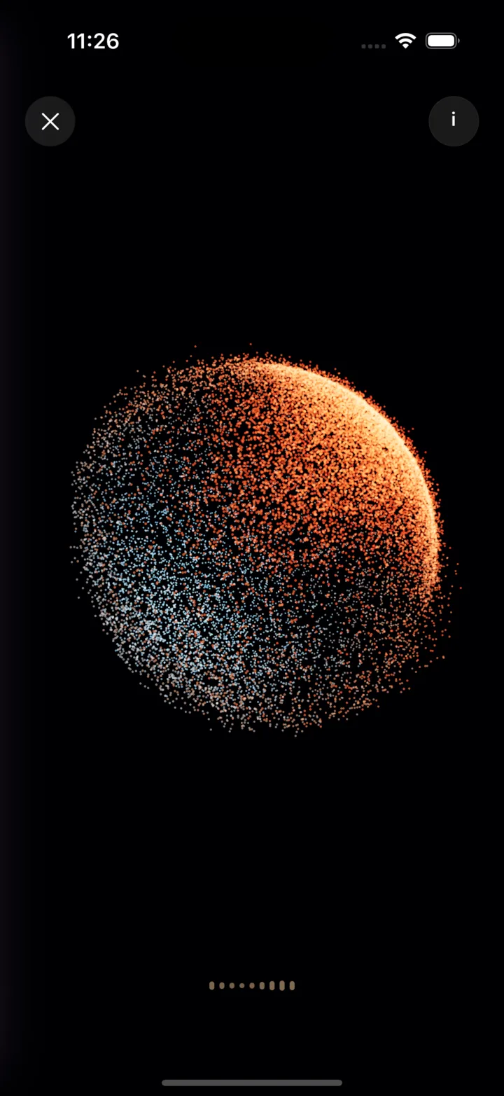 A Vocal Release session in the fine app: a sphere of thousands of particles shading from pale blue to coral, lit up by the voice.
